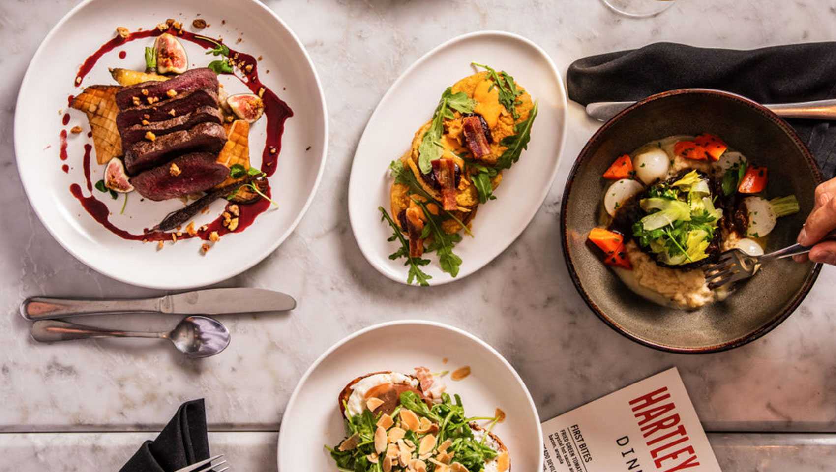 overhead photo of various food plates at Hartley