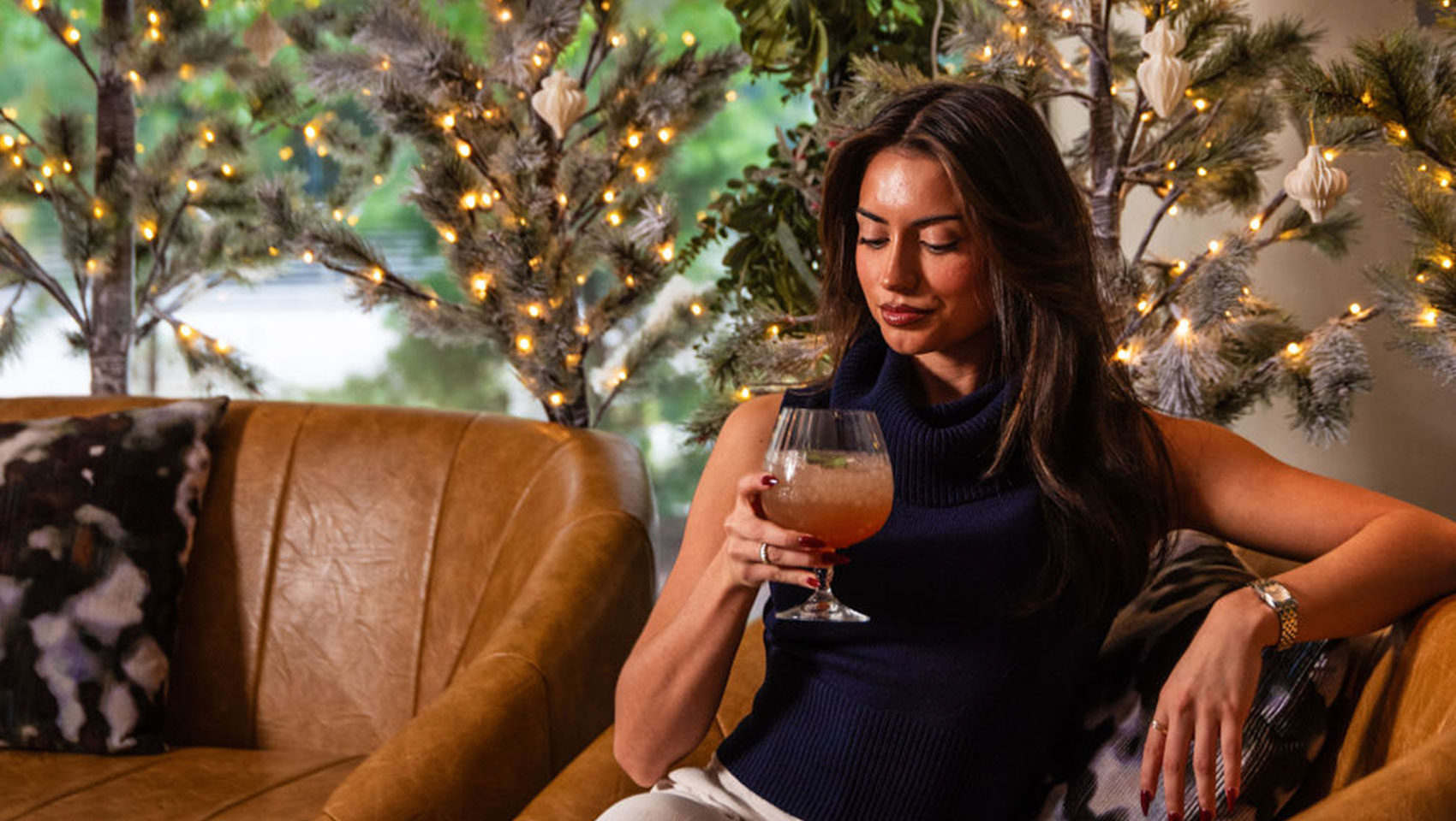 woman sitting and having a cocktail at the Winter Chalet