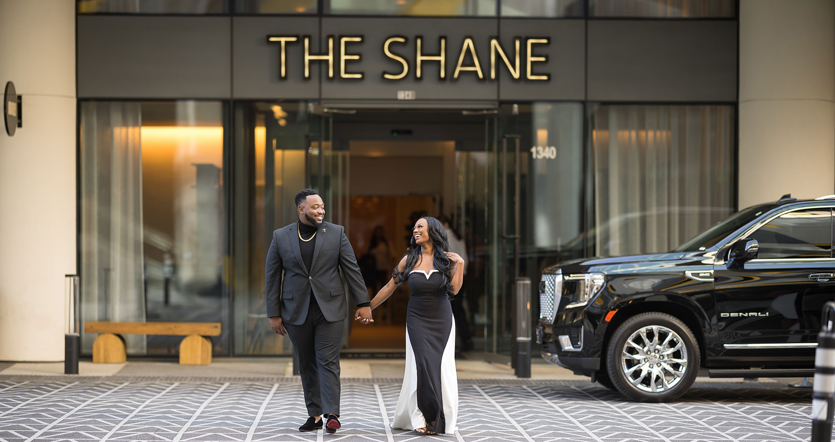 A young couple, just engaged, outside The Shane hotel